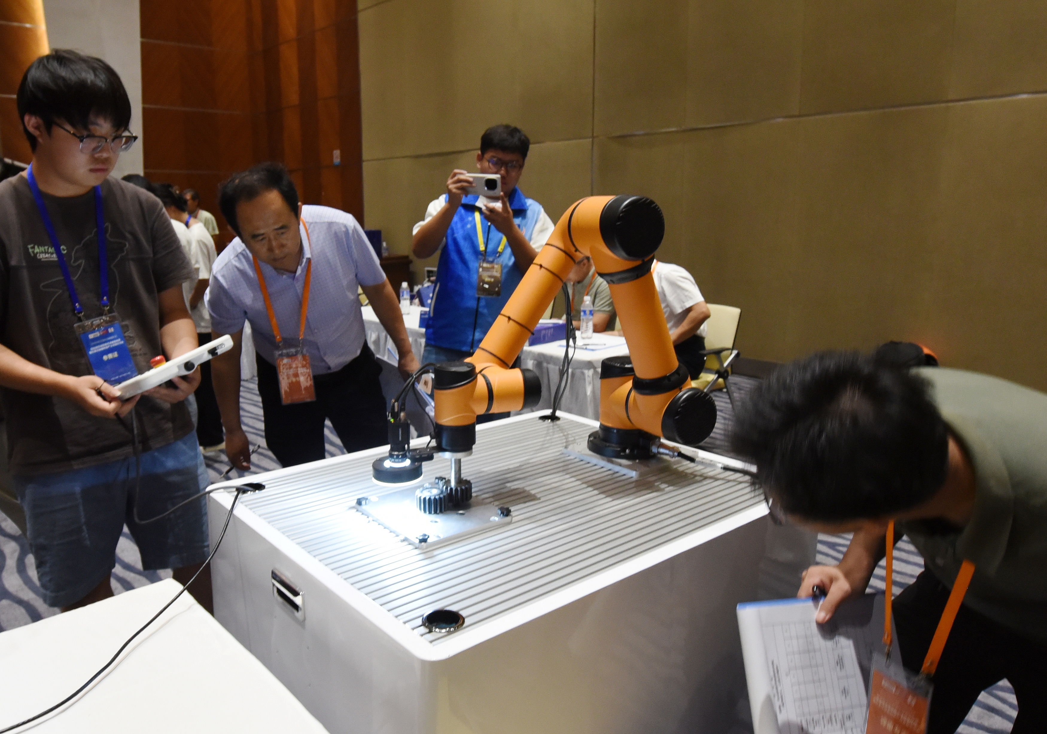 2025年中國大學(xué)生機械工程創(chuàng)新創(chuàng)意大賽智能精密裝配賽京津冀魯聯(lián)賽現(xiàn)場，評委對參賽選手進行實操調(diào)試評比。